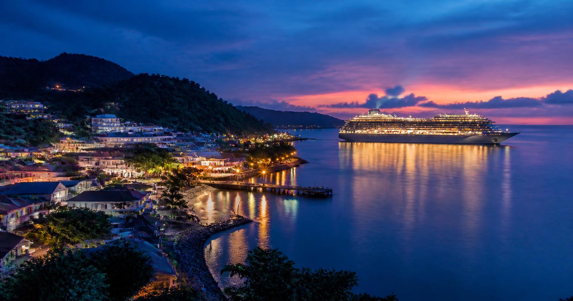 Cruise ship at sea under a golden sky
